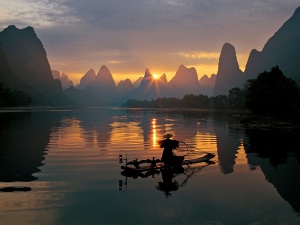 Fishermen and osprey in Li River Guilin